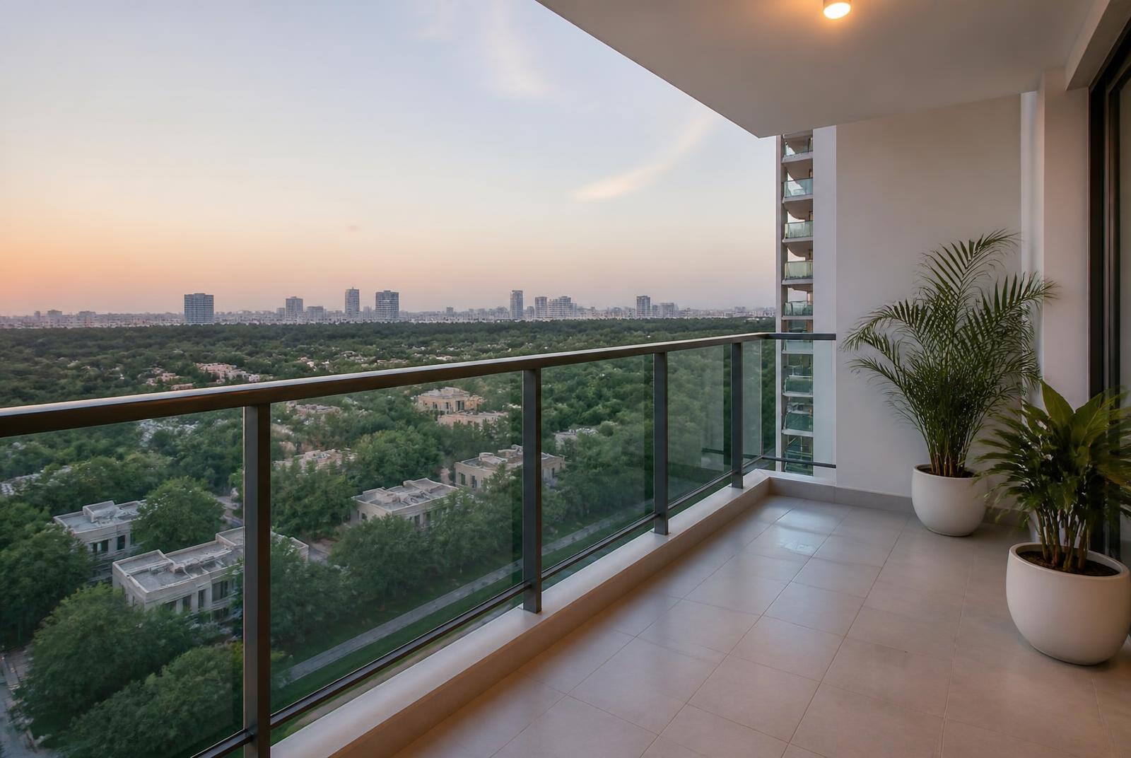 Balcony of a high-rise apartment overlooking landscaped greenery
